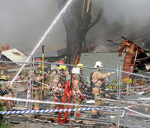 Firefighters battle a blaze after a gas explosion in Portland, Ore., Wednesday, Oct. 19, 2016. (AP Photo/Don Ryan)
