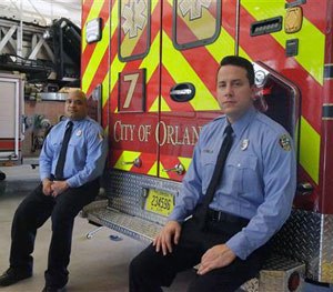 In this Thursday, June 30, 2016 photo, the first paramedic-firefighters to respond to the Pulse nightclub shooting stand by their emergency vehicle at their fire station in Orlando, Fla.