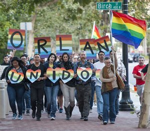 Several hundred supporters marched after a vigil in support of the Orlando shooting victims Sunday, June 12, 2016, in Santa Ana, Calif.