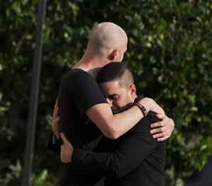 Mourners embrace outside the visitation for Pulse nightclub shooting victim Javier Jorge-Reyes on Wednesday, June 15, 2016, in Orlando, Fla.