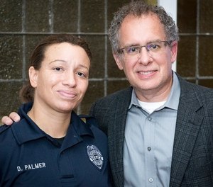 Officer Desiree Palmer poses with filmmaker Conrad Weaver. Weaver is producing a documentary called PTSD911, a film about mental health and first responders.