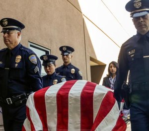 Palm Springs police officers carry the casket of officer Jose "Gil" Vegaat Palm Springs Convention Center on Oct. 18. (Photo/Los Angeles Times)
