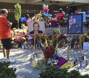 Mourners pay their respects on October 10, 2016, at a memorial for two slain Palm Springs, Calif., police officers, Lesley Zerebny, a new mom with a 4-month-old baby girl, and officer Jose