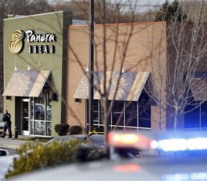 An investigator walks at the scene of a shooting at a shopping center in Abingdon, Md., Wednesday, Feb. 10, 2016.