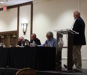 Panelists Jay Bradshaw (standing), Joe Schmider, Andy Gienapp and Tom Nehring discuss challenges facing rural EMS. 