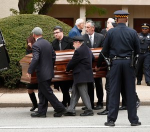 Pittsburgh police stand guard as pallbearers carry the casket of Irving Younger, 69, from Congregation Rodef Shalom after his funeral on Wednesday, Oct. 31, 2018, in Pittsburgh. Younger was one of the eleven victims killed in the deadly shooting at a synagogue in Pittsburgh's Squirrel Hill neighborhood on Saturday.