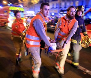 A woman is evacuated from the Bataclan concert hall after a shooting in Paris on Nov. 13. (AP Photo/Thibault Camus, File)