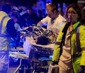 A person is evacuated after a shooting, outside the Bataclan theater in Paris.
