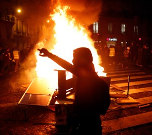 Demonstrators gather around a burning barricade during clashes with riots police, in Paris, France, Saturday, Dec. 8, 2018. (AP Photo/Thibault Camus)