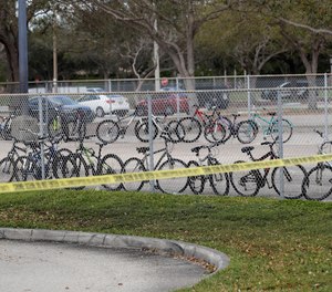 Un-retrieved bicycles appear inside the fence of Marjory Stoneman Douglas High School, Sunday, Feb. 18, 2018.