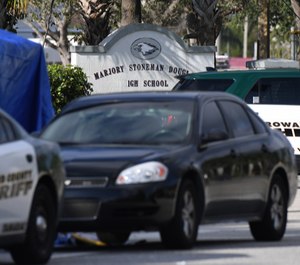 Broward Sheriff Deputy units are seen behing Marjory Stoneman Douglas High School in Parkland, Thursday, Feb. 15, 2018.