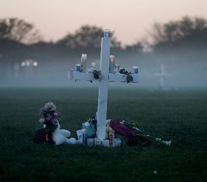 An early morning fog rises where 17 memorial crosses were placed, for the 17 deceased students and faculty from the Wednesday shooting at Marjory Stoneman Douglas High School, in Parkland, Fla., Saturday, Feb. 17, 2018.