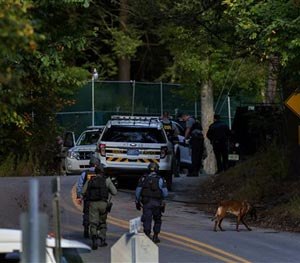 In this Monday, Sept. 22, 2014 photo, law enforcement personnel continue their search for Eric Frein, the suspect in the ambush at the Pennsylvania State Police barracks in Blooming Grove, in Monroe County, Pa. Frein is accused of killing Cpl. Bryon Dickson, 38, and critically wounding Trooper Alex Douglass outside the remote post in the Pocono Mountains on Sept. 12.