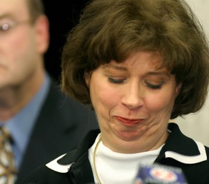 Wisconsin Attorney General Peg Lautenschlager reacts as she makes a statement to the media Thursday, Feb. 26, 2004, in Madison, Wis, about charges of operating a vehicle while intoxicated. (AP Photo/Andy Manis)