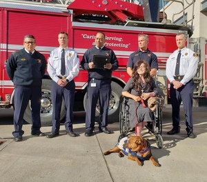 Dallas Firefighter Peter Hartnett (standing second from right) was recognized at a ceremony Monday for his lifesaving actions after Danyeil Townzen was set on fire by her ex-boyfriend.