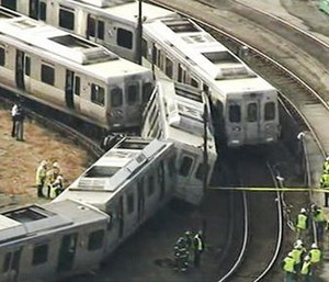 In this image from video provided by WPVI, officials investigate an accident involving out-of-service commuter trains in Upper Darby, Pa., Tuesday, Feb. 21, 2017.