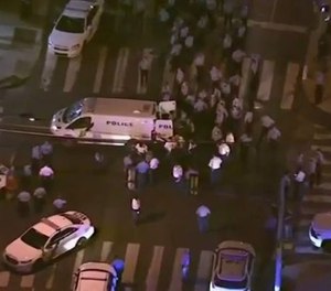 Police at the scene where two officers and five others were shot by a gunman.