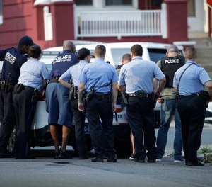 Police stage as they respond to an active shooting situation, Wednesday, Aug. 14, 2019. (AP Photo/Matt Rourke)