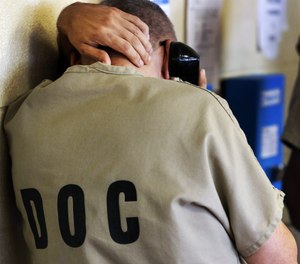 An inmate uses a phone at the Cook County Jail in Chicago