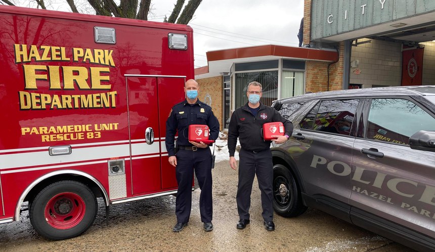 Hazel Park Police Chief Brian Bucholz and Fire Chief Richard Story pose with AEDs.