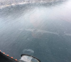 This aerial photo shows a 1,500-foot-long sheen left on the surface of the Unalaska Bay following the crash of a medevac plane into the waters. All three crewmembers on board the flight survived and were rescued. (Photo/U.S. Coast Guard)