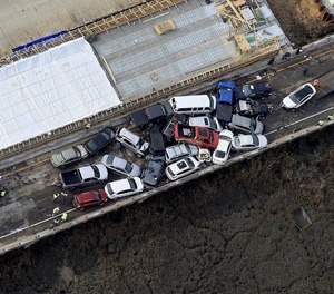 Crews work to clear vehicles from the Queens Creek overpass on I-64 in York County, Va., Sunday December 22, 2019 after a chain-reaction crash involving multiple vehicles cars. The crash happened Sunday morning. (Photo/Rob Ostermaier, The Daily Press via AP)
