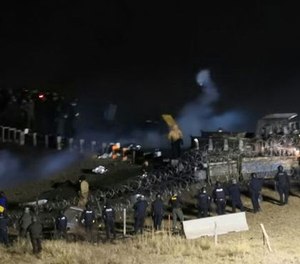 In this image provided by Morton County Sheriff’s Department, law enforcement and protesters clash near the site of the Dakota Access pipeline on Sunday, Nov. 20, 2016, in Cannon Ball, N.D. (Morton County Sheriff’s Department via AP)