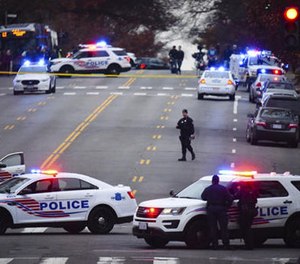 Police secure the scene near Comet Ping Pong in Washington, Sunday, Dec. 4, 2016.