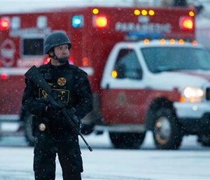 An officer stands guard near a Planned Parenthood clinic Friday, Nov. 27, 2015, in Colorado Springs, Colo. (AP Photo/David Zalubowski)