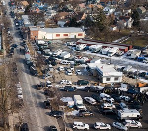 Law enforcement personnel gather near the scene of a shooting at an industrial park in Aurora, Ill. A report on the February shooting at the suburban Chicago manufacturing plant found that the man who killed five people after he was fired told another employee that if he lost his job he would kill other workers and "blow police up." (Bev Horne//Daily Herald via AP, File)