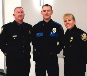 Sergeant Tyler Reddington (center) pictured with his parents. (Photo/Lisa Reddington)