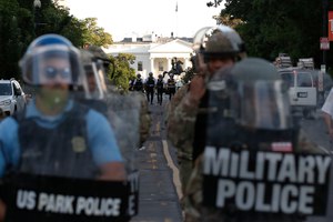 In this Monday, June 1, 2020, photo, police clear the area around Lafayette Park and the White House in Washington, as demonstrators gather to protest the death of George Floyd, a black man who died after being restrained by Minneapolis police officers. Image: AP Photo/Alex Brandon