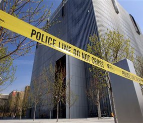Police tape surrounds the Federal Courthouse Monday, April 21, 2014, in Salt Lake City. A U.S. marshal shot and critically wounded a defendant on Monday in a new federal courthouse after the man rushed the witness stand with a pen at his trial in Salt Lake City, authorities said.