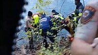 Video: Mo. police officers swim across cold pond to help firefighter save crashed vehicle's driver