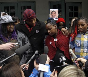 Venus Hayes, second from right, is surrounded by family members as she speaks during a press conference in Portland, Ore., Wednesday, March 22, 2017.