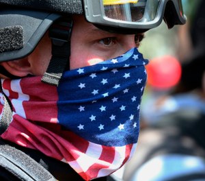 In this Aug. 4, 2018, file photo, a protester participates in a rally in Portland, Ore. (Mark Graves/The Oregonian via AP, File)