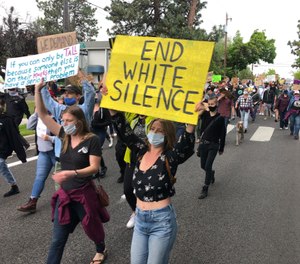 Demonstrators march Saturday, June 6, 2020, in Bend, Ore., to protest racism and police brutality. (AP Photo/Andrew Selsky)
