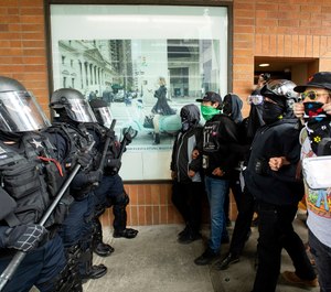 Police officers face off against protesters opposed to right-wing demonstrators following an