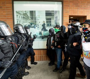 Police officers face off against protesters opposed to right-wing demonstrators following an 