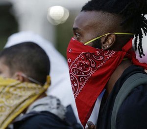 Demonstrators stand on the street in downtown protesting Tuesday's fatal police shooting of Keith Lamont Scott in Charlotte, N.C. on Thursday, Sept. 22, 2016.