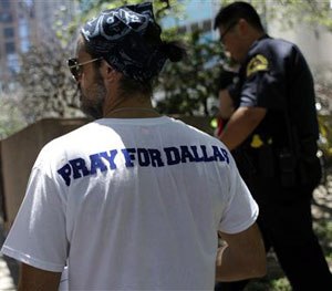 People take part in a prayer vigil at Thanksgiving Square, Friday, July 8, 2016, in Dallas. (AP Image)