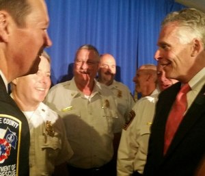 Dan Eggleston, IAFC director-at-large and fire chief of the Albemarle County (Va.) Fire and Rescue, greets Virginia Gov. Terence R. McAuliffe at FirstNet event in Reston, Va. (Photo/IAFC)