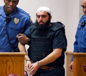 In this file photo from Tuesday, Dec. 20, 2016, Ahmad Khan Rahimi, the man accused of setting off bombs in New Jersey and New York in September is led into court in Elizabeth, N.J.