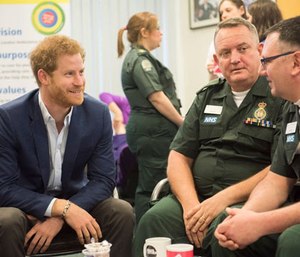 Prince Harry speaking with London Ambulance personnel.