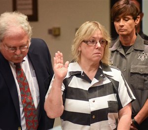 In this July 28, 2015 file photo, Joyce Mitchell raises her hand during a court appearance in Plattsburgh, N.Y. (AP Image)