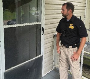 In this photo, an officer checks on one of his cases in Baton Rouge, La. (AP Photo/R.J. Rico)