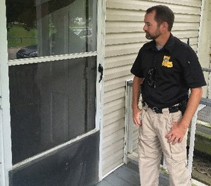 In this photo, an officer checks on one of his cases in Baton Rouge, La.