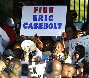 Demonstrators gather near a community pool Monday, June 8, 2015. (AP Image)