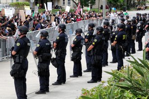 In this June 3, 2020 photo, protesters shout at officers lined up in front of the Orlando Police Department in Orlando, Fla. Experts say community trust is severely hampered when law enforcement agencies are unable to remove officers for misconduct. Image: Joe Burbank/Orlando Sentinel via AP