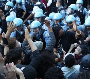 Protesters push against Chicago police near the Trump International Hotel & Tower on May 30, 2020. (Photo/TNS)